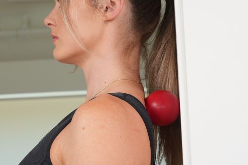 Knuklball used against wall to release tight muscles in upper back